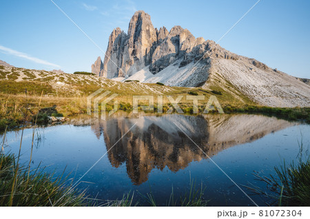 Famous Tre Cime di Lavaredo reflected in small pond, Dolomites Alps Mountains, Italy, Europe. Tre Cime mount in Dolomites Famous Tre Cime di Lavaredo reflected in small pond, Dolomites Alps Mountains, Italy, Europe. Tre Cime mount in Dolomites 81072304