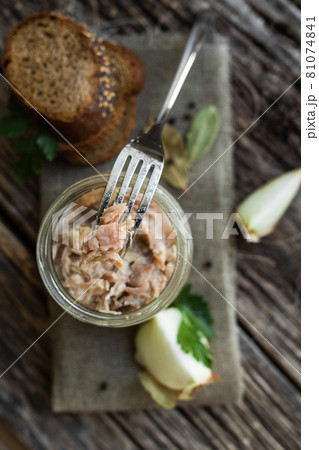 Stew in a glass jar, herbs and vegetables, bread on a wooden table. Preservation and storage of products. Stew in a glass jar, herbs and vegetables, bread on a wooden table. Preservation and storage of products. 81074841