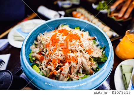 Cold platter in a blue bowl with avocado and crab meat flavored with orange spice Cold platter in a blue bowl with avocado and crab meat flavored with orange spice 81075215