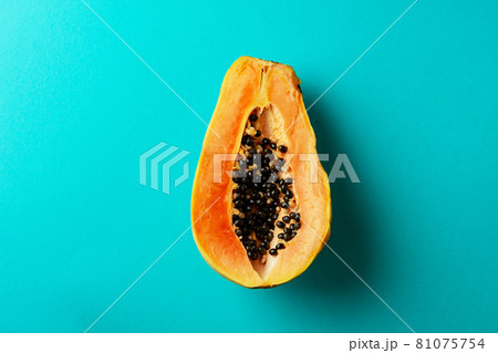 Summer composition. Tropical papaya fruits cut in half lie on a blue background. Summer concept. Flat lay, top view, copy space 81075754