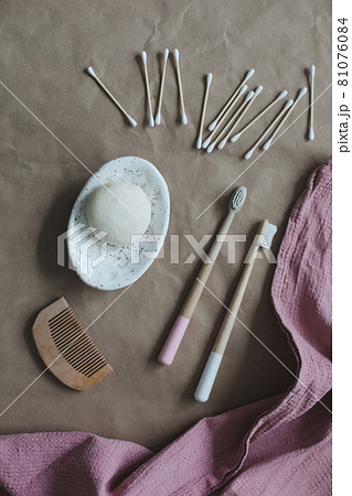 Eco spa friendly products. Handmade natural soap, wooden toothbrushes, cotton swabs and hairbrush on craft paper background top view with copyspace Eco spa friendly products. Handmade natural soap, wooden toothbrushes, cotton swabs and hairbrush on craft paper background top view with copyspace 81076084