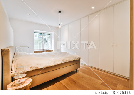 Interior of a cozy and bright bedroom with beautiful decoration Interior of a cozy and bright bedroom with beautiful decoration 81076338