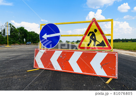 Road works sign on the road. Attention road repair. 81076805