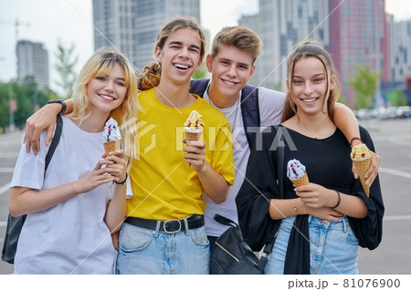 Group portrait of happy teenagers having fun with ice cream. 81076900