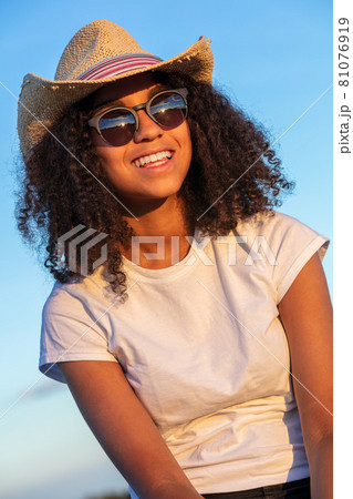 Mixed Race African American Teenager Young Woman In Cowboy Hat and Sunglasses Mixed Race African American Teenager Young Woman In Cowboy Hat and Sunglasses 81076919