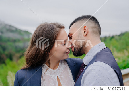 the bride and groom kiss tenderly in nature. romance in the relationship 81077311