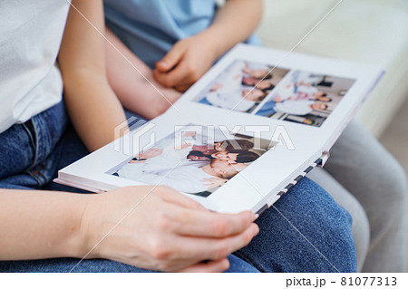 top view. mother and daughter watch photobook from discharge of newborn baby 81077313