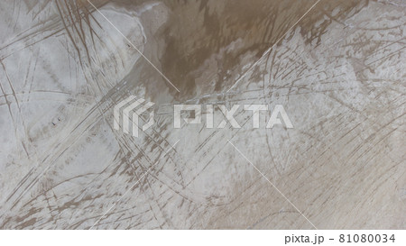 The bottom of a dried up salt lake. View from the air. Traces of cars and motorcycles in the sand. 81080034