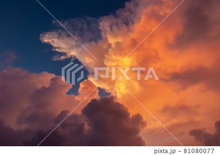 Gorgeous huge colorful clouds illuminated by magic sunset light contrasting with blue sky. Iriomote Island. 81080077
