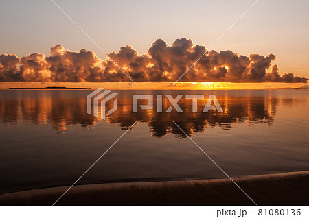 Gorgeous sunrise with incredible clouds formation reflected in the ocean like a mirror. Iriomote Island. Gorgeous sunrise with incredible clouds formation reflected in the ocean like a mirror. Iriomote Island. 81080136