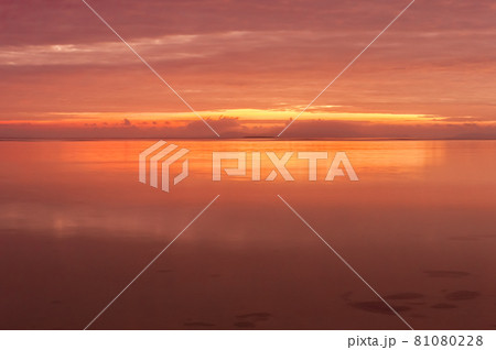Radiant sunrise by the seashore in pink color reflecting throughout the scene. Iriomote Island. 81080228