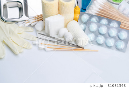 Wound care dressing set. Forceps, cotton stick, conform bandage, elastic cohesive retention bandage, cotton ball with alcohol, latex disposable gloves, and povidone-iodine. Medical supply for nurses. Wound care dressing set. Forceps, cotton stick, conform bandage, elastic cohesive retention bandage, cotton ball with alcohol, latex disposable gloves, and povidone-iodine. Medical supply for nurses. 81081548