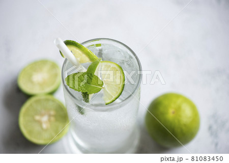 Summer drink juicy lime slice top view, Exotic summer drinks refreshing of cold drinks glasses fresh fruit on ice homemade cocktail tea with mojito lemon lime and mint leaf 81083450