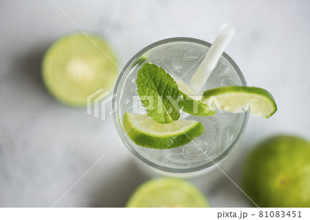 Summer drink juicy lime slice top view, Exotic summer drinks refreshing of cold drinks glasses fresh fruit on ice homemade cocktail tea with mojito lemon lime and mint leaf Summer drink juicy lime slice top view, Exotic summer drinks refreshing of cold drinks glasses fresh fruit on ice homemade cocktail tea with mojito lemon lime and mint leaf 81083451