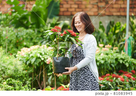 Happy Woman with Blooming Flower 81083945