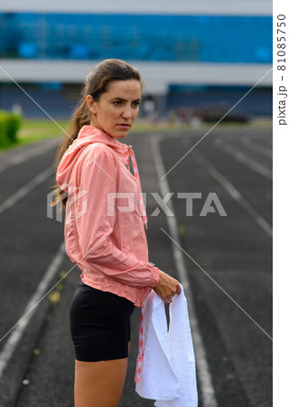 Outdoor shot of young woman athlete running on racetrack. Professional sportswoman during training. Outdoor shot of young woman athlete running on racetrack. Professional sportswoman during training. 81085750