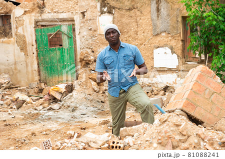 African man behind damaged building African man behind damaged building 81088241