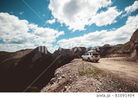 Driving off road car on high altitude mountain top 81091404