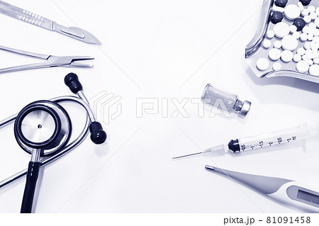 The Surgical instruments, stethoscope, digital thermometer, vial of drug, 3 ml plastic syringe with needle and drug tablets on the medication tray  isolated on the white background 81091458