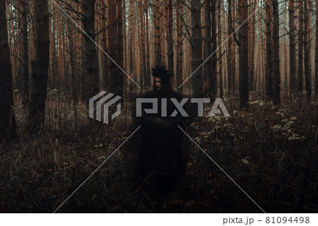 blurry frightening black silhouette of an evil witch casting spells blurry frightening black silhouette of an evil witch casting spells 81094498