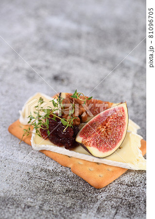 Cracker with a slice of camembert with confiture and figs Cracker with a slice of camembert with confiture and figs 81096705