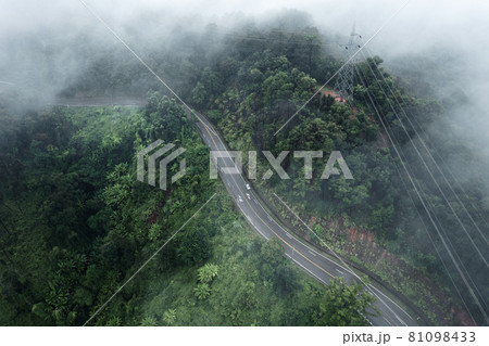 Mountain road in rainy and foggy day 81098433