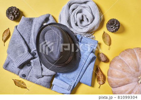 Baby autumn wear clothes on yellow background. Top view. Overhead view of warm kid autumn clothes on colored backdrop Baby autumn wear clothes on yellow background. Top view. Overhead view of warm kid autumn clothes on colored backdrop 81099304