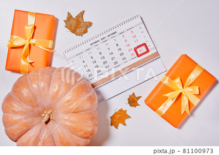 October 2021 monthly calendar, gift box and pupmkin on white background. Top view. Overhead view of Autumn month - October calendar October 2021 monthly calendar, gift box and pupmkin on white background. Top view. Overhead view of Autumn month - October calendar 81100973