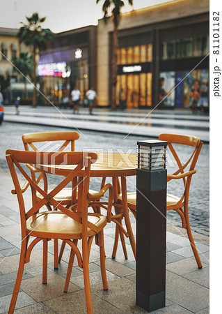 Empty table and chairs of street cafe 81101182