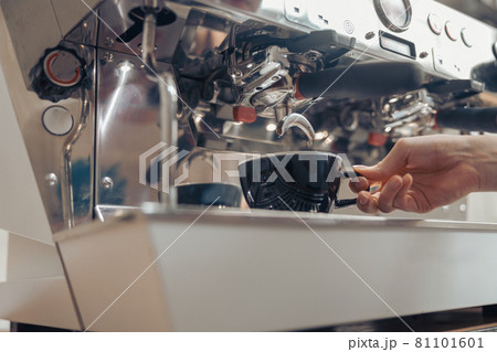 Female barista making fresh espresso in cafeteria Female barista making fresh espresso in cafeteria 81101601