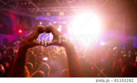 Love to music. Male heart shaped hands and crowd or audience at live music concert Love to music. Male heart shaped hands and crowd or audience at live music concert 81103282