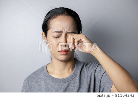 Woman suffering from strong eye pain. 81104242