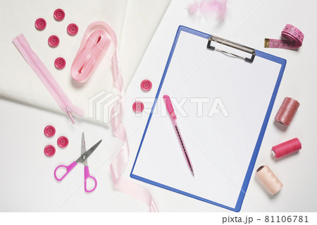 Sewing items from above. Flat lay composition with sewing accessories on light color background. Items for sewing, Sewing clothes, measuring tape, tailoring scissors, threads, buttons and needles 81106781