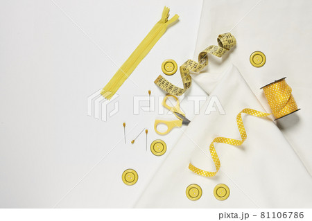 Sewing items from above. Flat lay composition with sewing accessories on light color background. Items for sewing, Sewing clothes, measuring tape, tailoring scissors, threads, buttons and needles Sewing items from above. Flat lay composition with sewing accessories on light color background. Items for sewing, Sewing clothes, measuring tape, tailoring scissors, threads, buttons and needles 81106786
