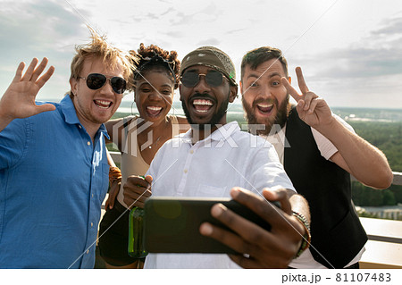Cheerful intercultural friends making selfie outdoors 81107483