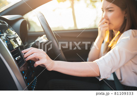 Young Asian woman holding her nose because of bad smell after turn on car air conditioning Young Asian woman holding her nose because of bad smell after turn on car air conditioning 81109333