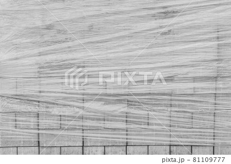 A pile of new paving stone slabs wrapped in plastic wrap background. Building tile materials at the construction site 81109777