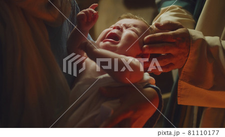 Mary and Joseph comforting crying baby Jesus 81110177