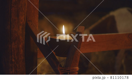 Candle illuminating stable on Christmas day 81110178