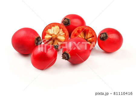 Rosehips ( Rosa Canina fruits ) , one cut in half, isolated on white background. 81110416