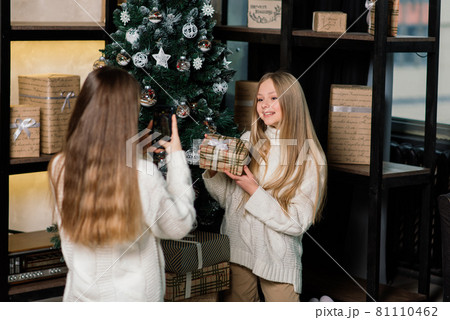 Two lovely girls posing with kissing face expression at birthday party. Long-haired european lady Two lovely girls posing with kissing face expression at birthday party. Long-haired european lady 81110462