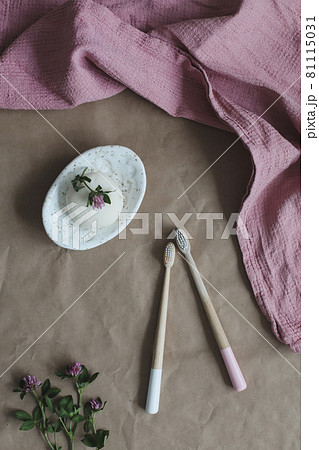 Soap bar or solid shampoo on a soap dish, bamboo toothbrush and towel top view with copyspace. Accessories for personal hygiene. Plastic free and eco friendly products in household Soap bar or solid shampoo on a soap dish, bamboo toothbrush and towel top view with copyspace. Accessories for personal hygiene. Plastic free and eco friendly products in household 81115031