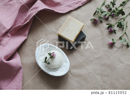 Natural organic soap with flowers and pink towel on craft paper background top view with copyspace Natural organic soap with flowers and pink towel on craft paper background top view with copyspace 81115052