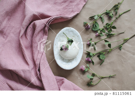 Natural organic soap with flowers and pink towel on craft paper background top view with copyspace Natural organic soap with flowers and pink towel on craft paper background top view with copyspace 81115061