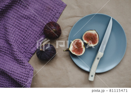 still life with ripe fresh figs with a knife and purple textiles on a table top view still life with ripe fresh figs with a knife and purple textiles on a table top view 81115471