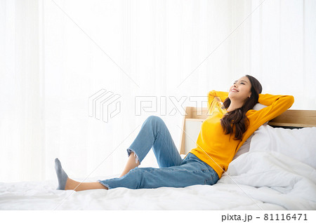 Happy woman relaxing on bed in bedroom. Freedom concept 81116471
