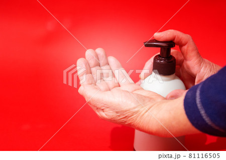 Woman push liquid soap squeezed out to hand. 81116505