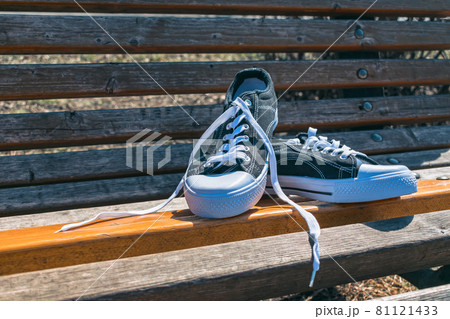 New sports sneakers on a park bench in summer New sports sneakers on a park bench in summer 81121433
