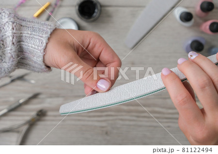 Modern female nude design manicure. Nail care, Self care. Professional Hardware Manicure. Procedure for the preparation of nails. Cuticle Pusher Remover. Nail file scissors Modern female nude design manicure. Nail care, Self care. Professional Hardware Manicure. Procedure for the preparation of nails. Cuticle Pusher Remover. Nail file scissors 81122494