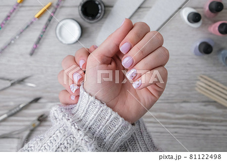 Modern female nude design manicure. Nail care, Self care. Professional Hardware Manicure. Procedure for the preparation of nails. Cuticle Pusher Remover. Nail file scissors Modern female nude design manicure. Nail care, Self care. Professional Hardware Manicure. Procedure for the preparation of nails. Cuticle Pusher Remover. Nail file scissors 81122498